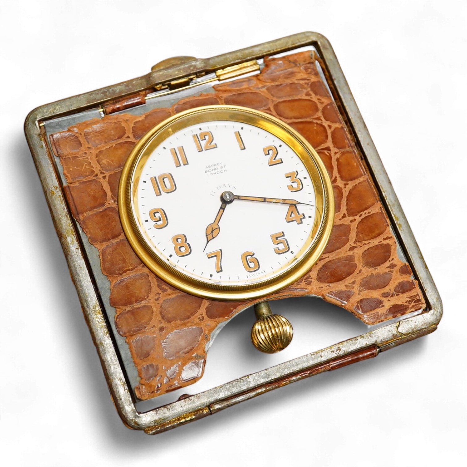 An Asprey crocodile inset travelling 8 day timepiece 10 cm high.